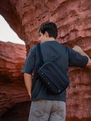Black crossbody gear bag for creators and tech users. Compact everyday carry with strong zippers.