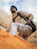 Built for movement camera backpack worn during a climb, showing secure fit and all-day comfort in rugged terrain.