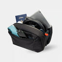 Slim sling bag holds travel tech accessories. Designed to fit inside any carry-on or tote.